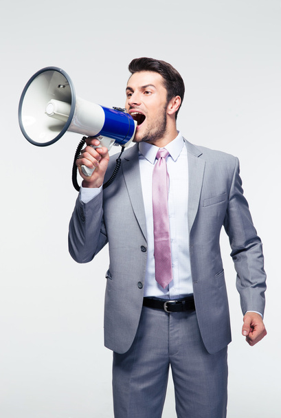 Businessman shouting in loudspeaker - Zdjęcie, obraz