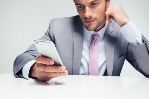 Confident businessman using smartphone - Фото, изображение