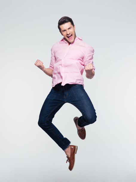 Businessman celebrating his success and jumping - Foto, afbeelding