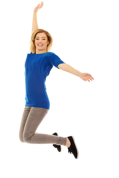 Young casual woman jumping. - Valokuva, kuva