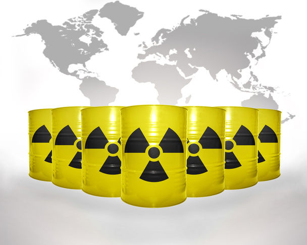 many yellow barrels with sign of radiation on the world map background - Photo, Image