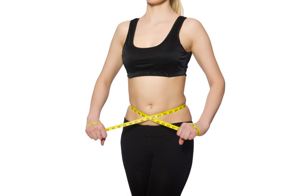 Young girl with centimeter in dieting concept - Foto, Imagen