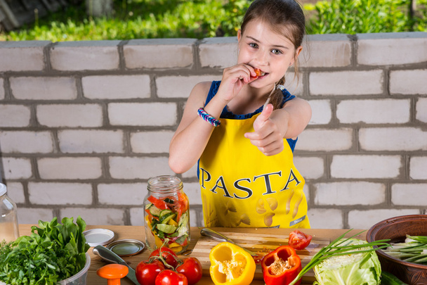 Girl Sampling Peppers and Giving Thumbs Up - Photo, image