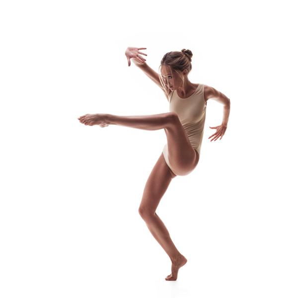 young beautiful dancer in beige swimsuit  - Фото, зображення