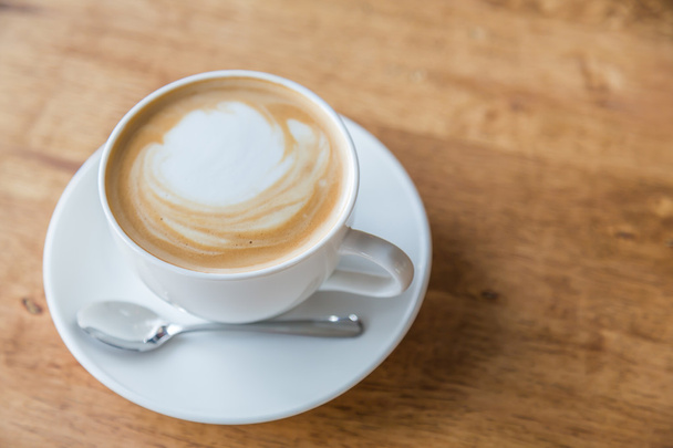 Coffee in white cup on wood table - Фото, зображення