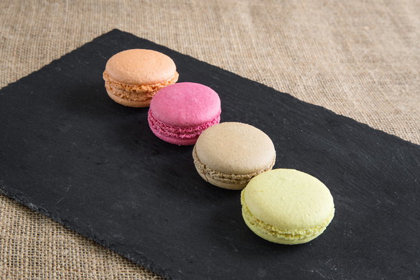 traditional french colorful macarons in a rows in a box - Foto, afbeelding