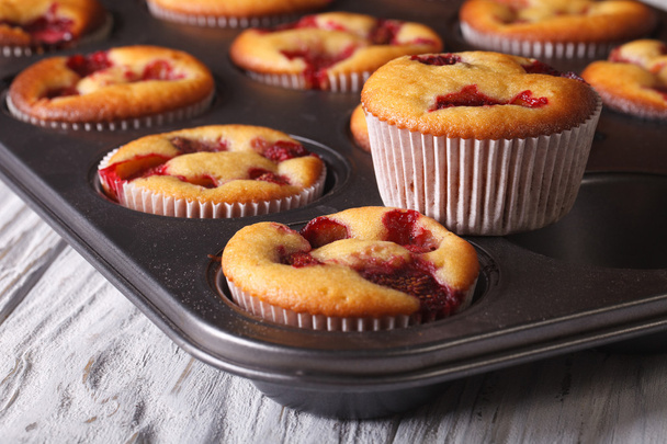 muffins with strawberries close up in baking dish. horizontal - Photo, Image