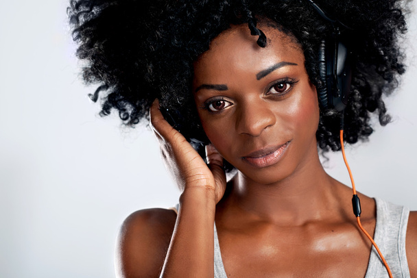 african woman with headphones - Фото, изображение