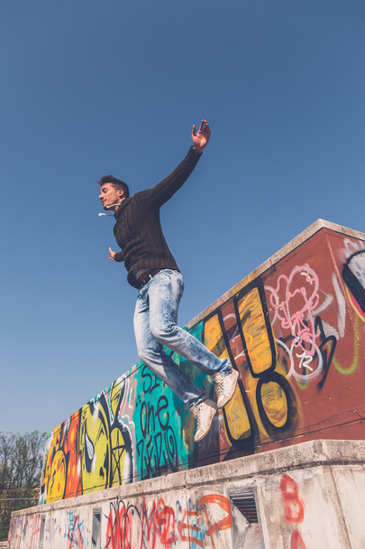 Young  man jumping in an urban context - 写真・画像