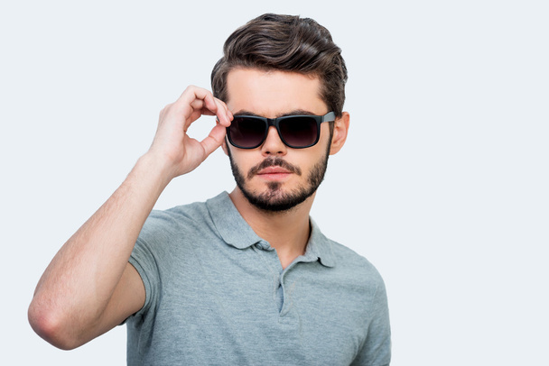Confident young man adjusting eyewear - Photo, Image