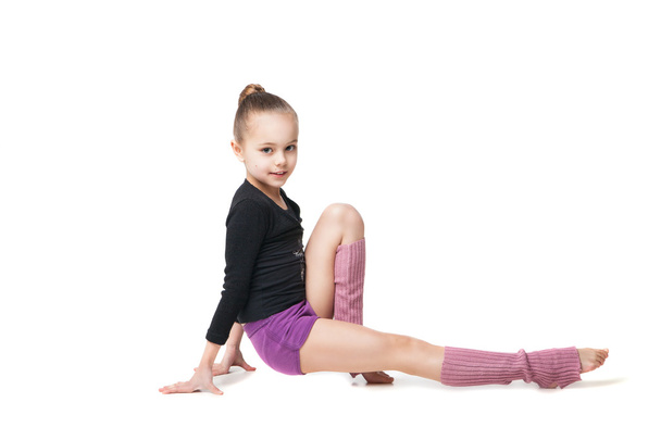 pretty little girl doing gymnastics over white background - Foto, afbeelding