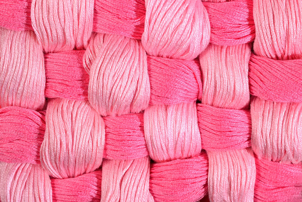Pink twisted skeins of floss as background texture - Фото, изображение