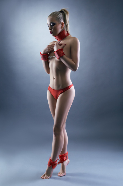 BDSM. Sensual submissive posing topless in studio - 写真・画像