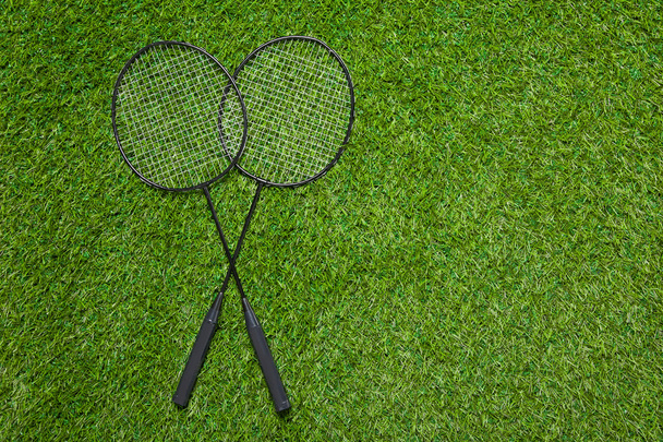 Badminton rackets lying on the grass - Zdjęcie, obraz