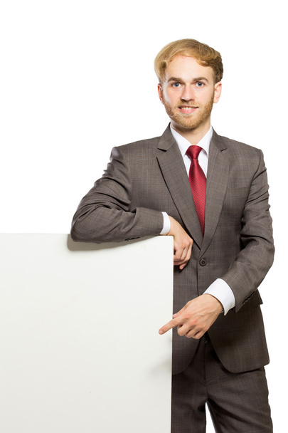 Young businessman standing while with a blank whiteboard , isola - Foto, afbeelding