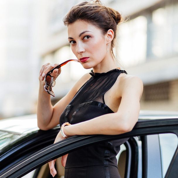 Attractive girl standing near the car - Zdjęcie, obraz