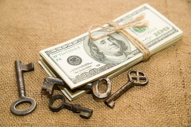 One pack of dollars and keys on an old cloth - Photo, Image