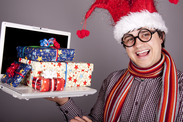 Funny men in christmas cap with gift boxes and notebook - 写真・画像