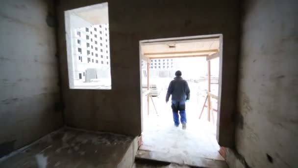 Worker goes out from building - Video