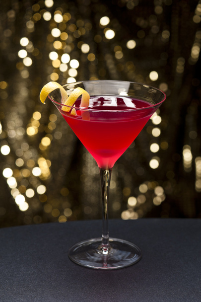 Cosmopolitan cocktail with lemon garnish - Fotó, kép