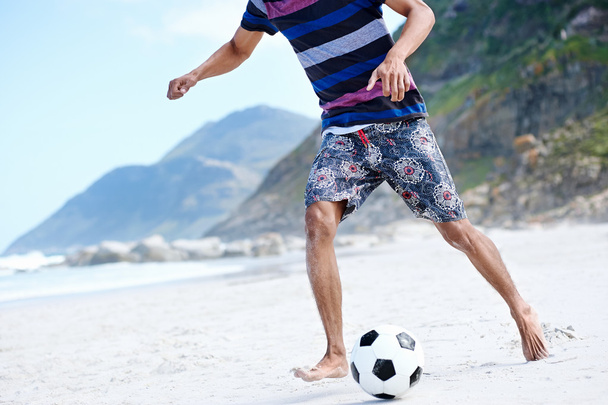 Brasil man playing soccer on beach - Fotó, kép