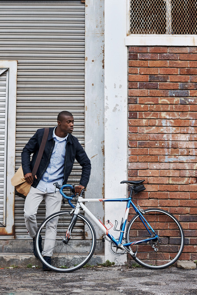 Man relaxing with bicycle in city - Photo, Image