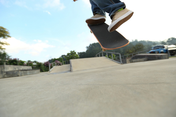 Skateboarder legs at skatepark - Фото, изображение