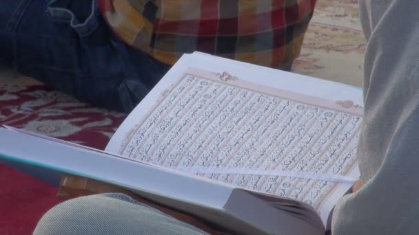 Close-up van de man die leest Quran. - Video