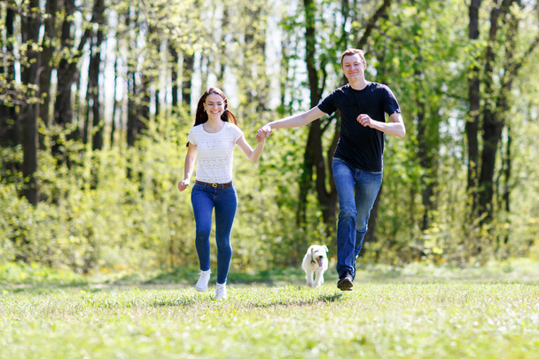 Happy young couple and  dog - Fotografie, Obrázek
