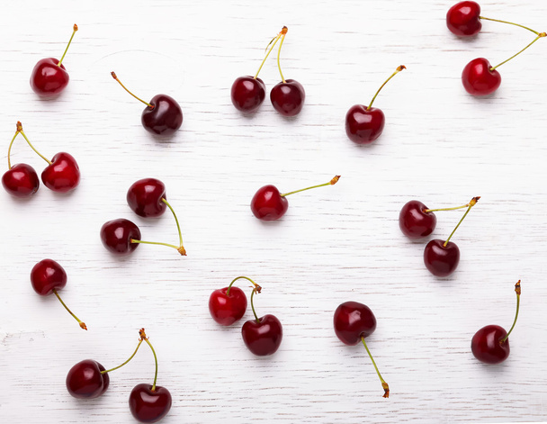 Fresh cherries on the white wooden background - Fotoğraf, Görsel