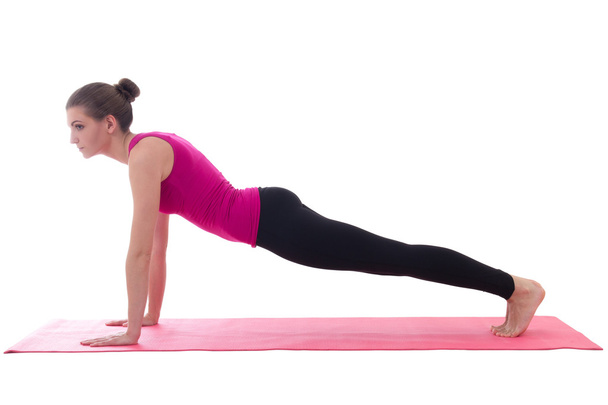 giovane e bella donna che fa push-up esercizio sull'isolato stuoia di yoga - Foto, immagini