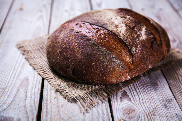 food, nice rye bread on a wooden background - Fotografie, Obrázek