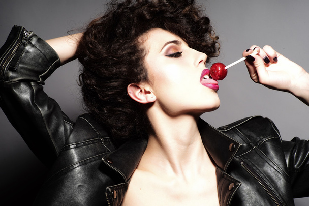 Passionate girl with lollipop - Zdjęcie, obraz