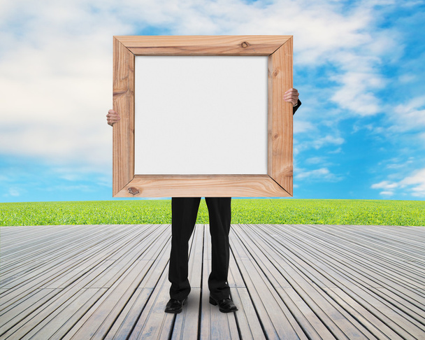 man holding blank white board with wooden frame - Fotografie, Obrázek