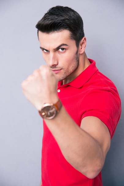 Young casual man showing fist - Фото, изображение