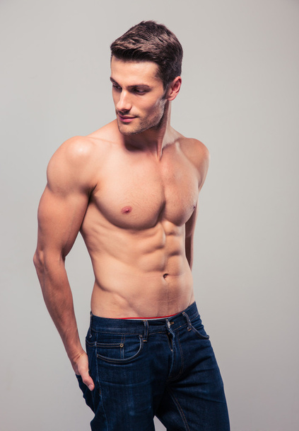 Muscular young man looking away - Photo, image