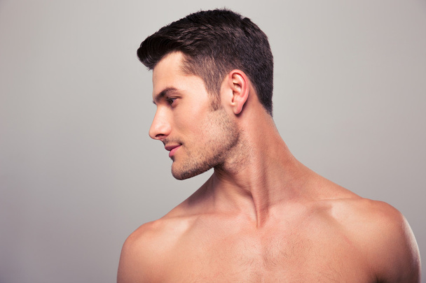 Young man with naked torso looking away  - Fotoğraf, Görsel