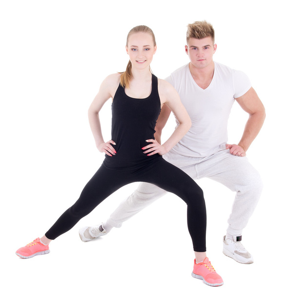sporty man and woman stretching isolated on white - Valokuva, kuva