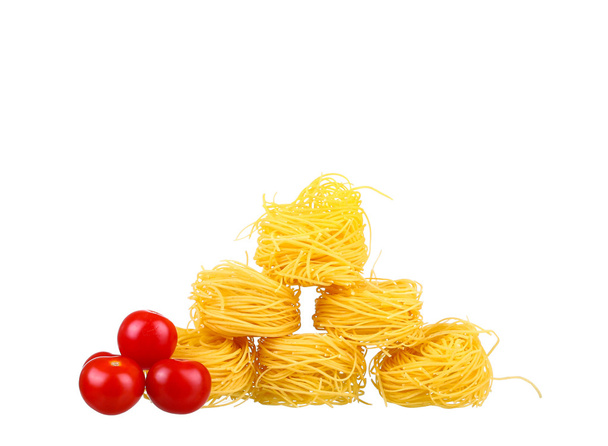 row dry nest pasta on white and cherry - Foto, imagen