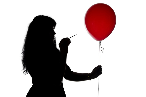 Photo pierced woman with a needle balloon  - Foto, afbeelding