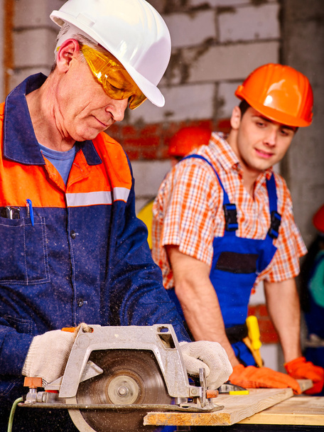 Group people  builders with circular saw . - Photo, Image