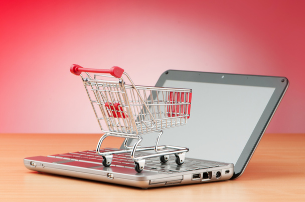 Internet online shopping concept with computer and cart - Φωτογραφία, εικόνα