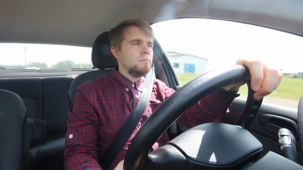 The young man behind the wheel happy - Footage, Video