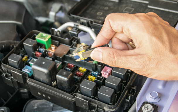 Auto mechanic checking a car fuse - Photo, Image
