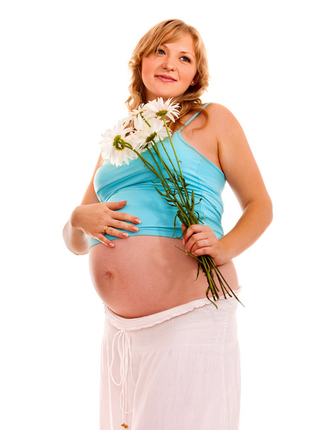 Pregnant woman with flowesr. - Фото, изображение