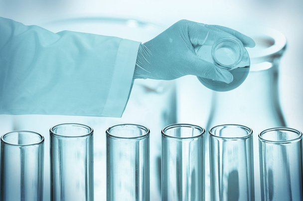 Scientist hand holding test tubes - Фото, изображение