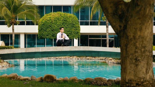 Businessman Meditating Doing Yoga Outside Office Building - Photo, Image