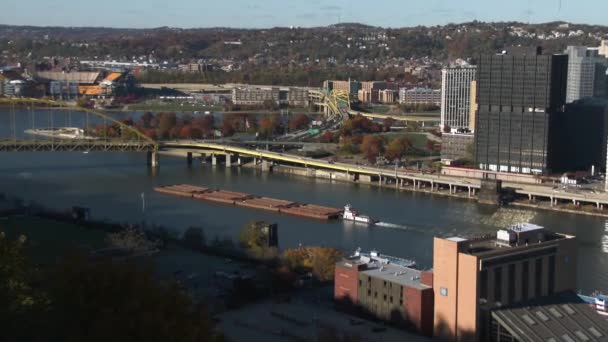 A barge heads up the Monongahela River near Pittsburgh, Pennsylvania.  May be suitable for editorial or documentary use only.  In 4K UltraHD. - Footage, Video