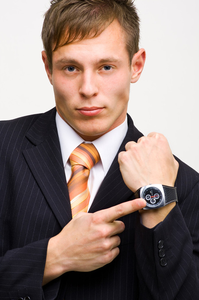 Angry young businessman showing time - Φωτογραφία, εικόνα