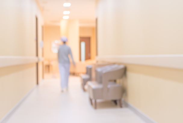 blur image of nurse in hospital walkway for background usage. - Photo, Image